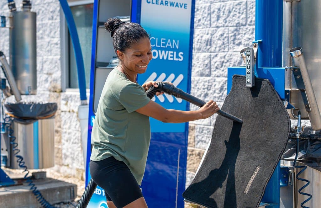A Clearwave Alsip team member at the free microfiber towel and mat cleaning station